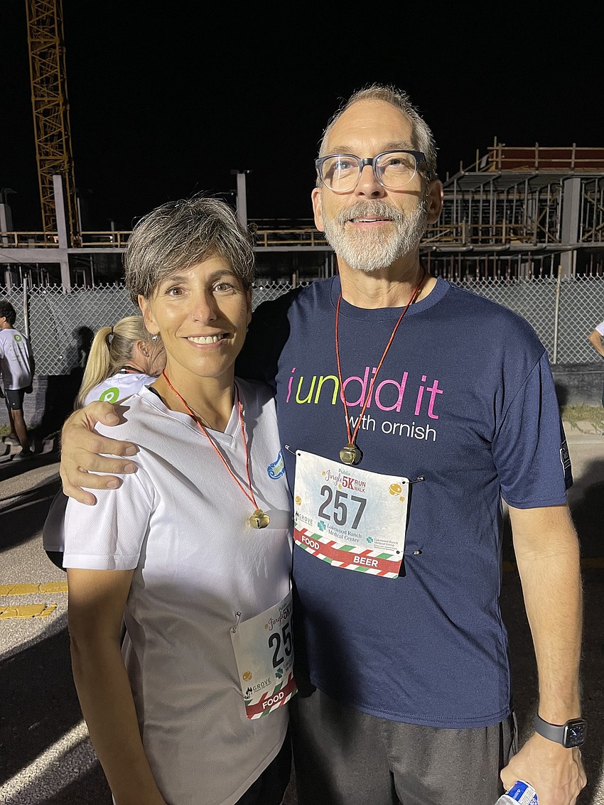 Sarasota's Bobbi and Bruce Larsen enjoy a moment on Health Park Way prior to the start of the Jingle Run. Bruce Larsen had open heart surgery six months ago and spent time at Lakewood Ranch Medical Center during his recovery.