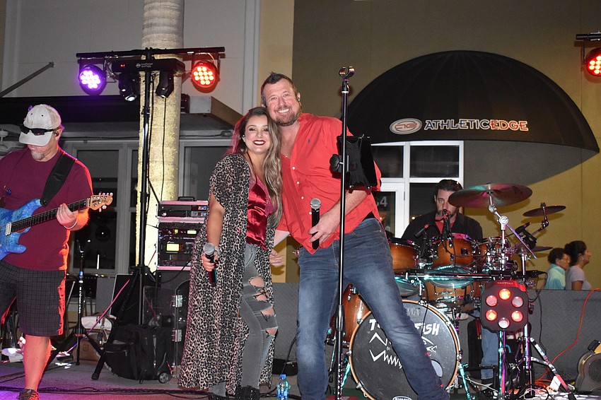 Stevie Louda and Scott Murphy of the Sarasota-based band Triggerfish entertain the crowd returning from the Jingle Run.