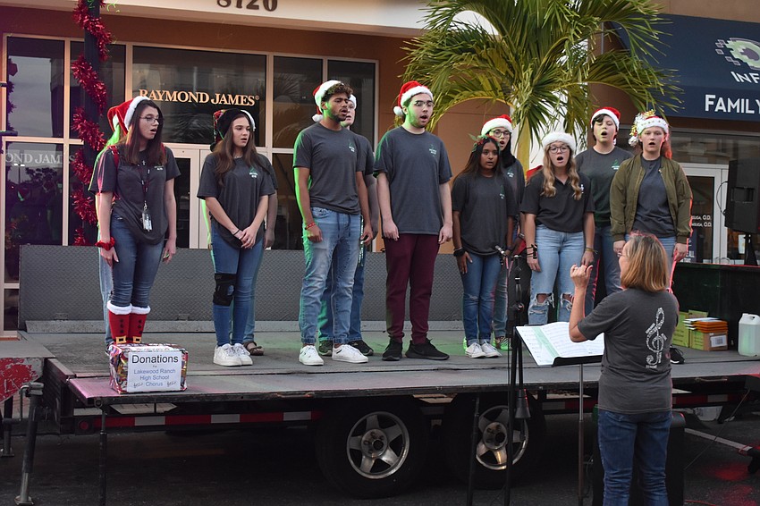 The Lakewood Ranch High School Chorus sings for the early arrivals to the Jingle Run festivities.