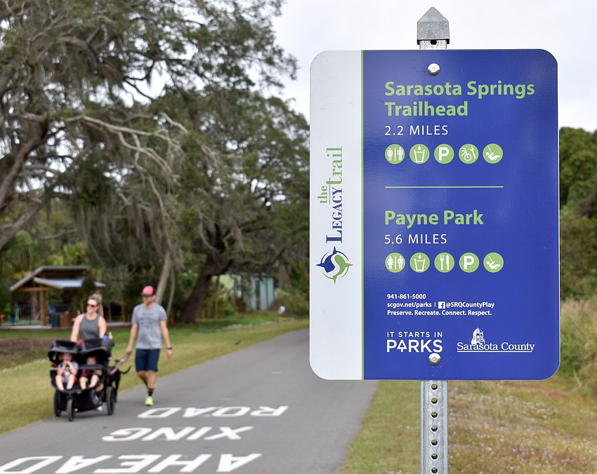 Katie and Matt Hart walk with their two children, Ellie and Lincoln and their dog, Maddie.