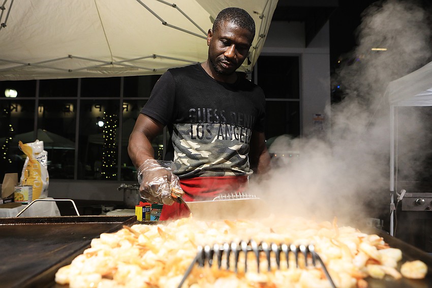 Amidau Conate cooks up food.