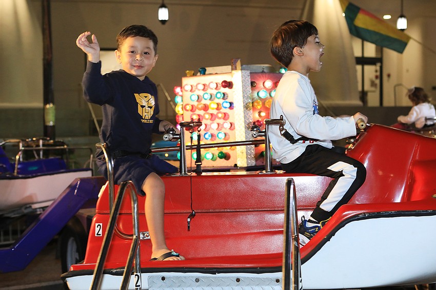 Flynn Ngo and Alex Popkov enjoy a carnival ride.