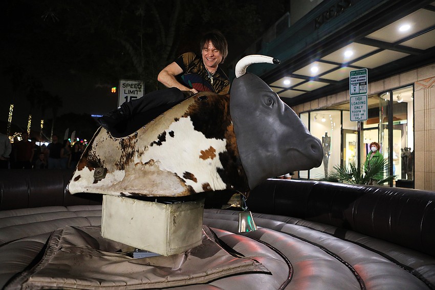 Cedric Noel hangs onto the mechanical bull.