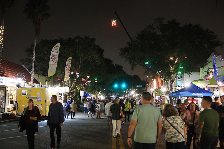 Families and friends stroll through the Main Street area during the block party.