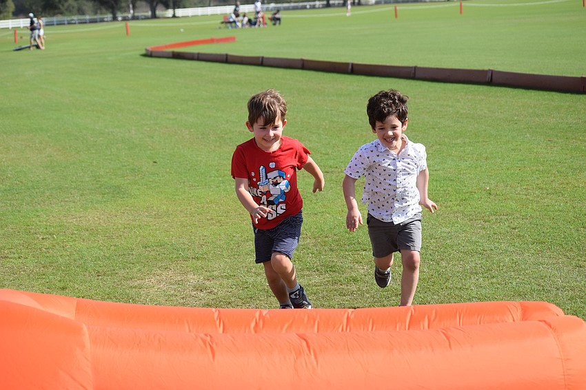 Evan Thomas, a 6-year-old from Berlin, Germany, and Luca Misiti, a 4-year-old from Sarasota, run to jump into an inflatable before the two of them ...