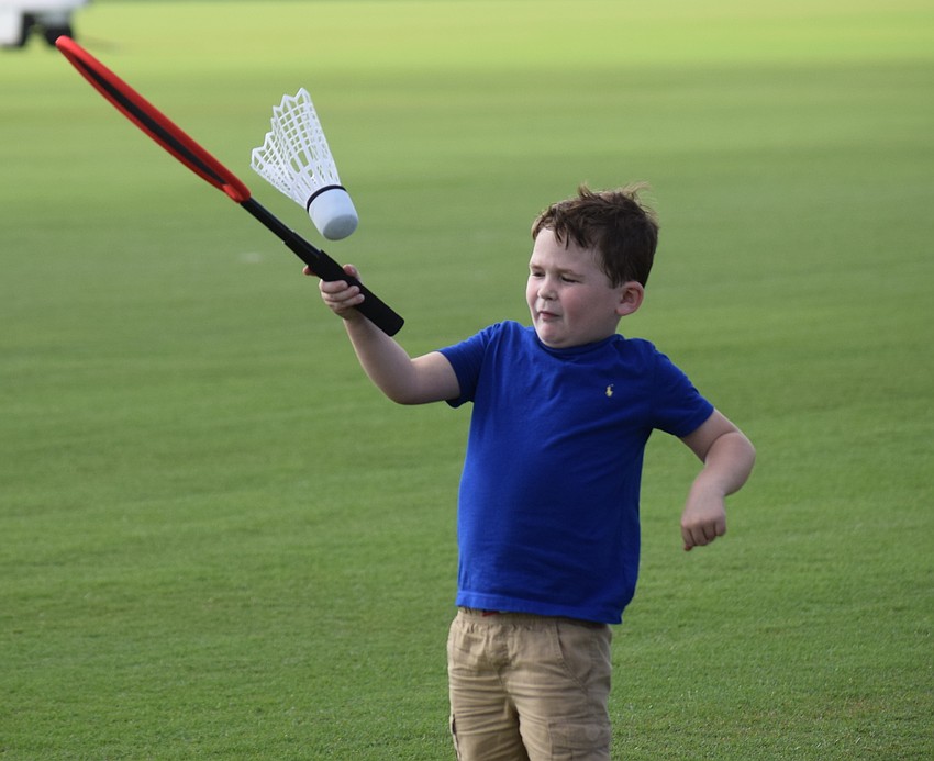 East County 5-year-old Blake Tennant tries his luck at a badminton type of game on the field before polo.