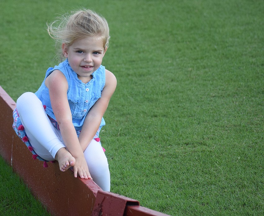 Three-year-old Charlie Sanders of Sarasota might have been attending the polo match, but she was having fun testing her balance along the sideline.