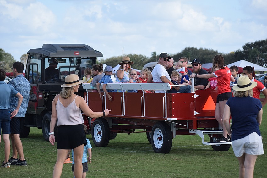 Pandemic restrictions have kept the Clydesdales from pulling the wagon at halftime, but kids still enjoy a wagon ride pulled by a tractor.