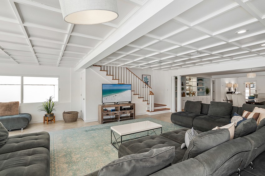 Vaulted and coffered ceilings are featured throughout the main level.