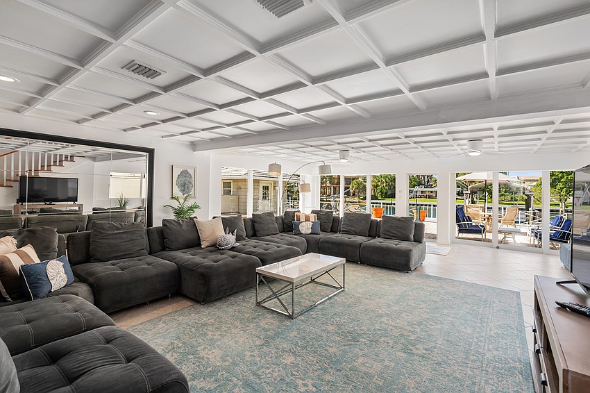 Vaulted and coffered ceilings are featured throughout the main level.