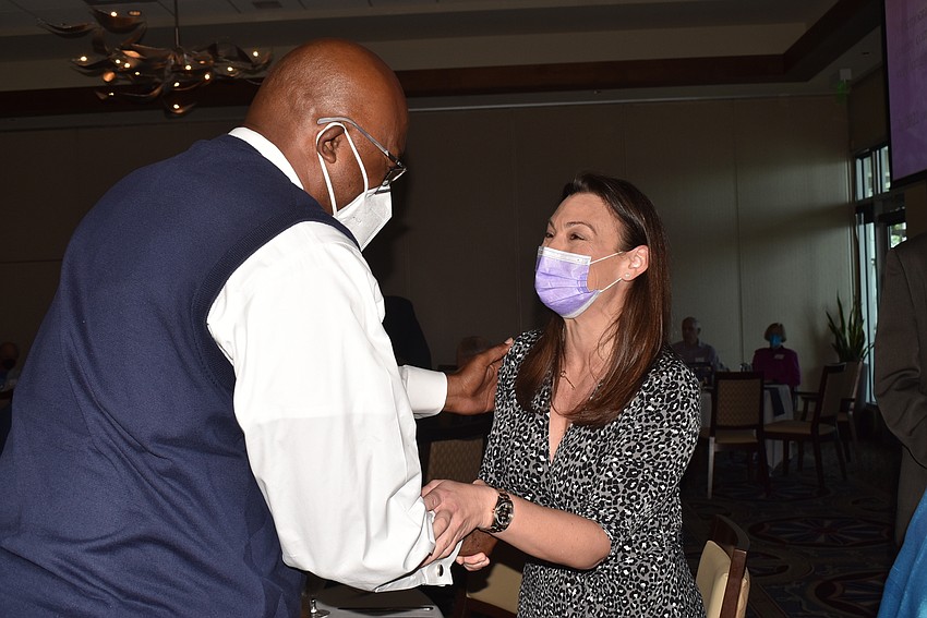 Reggie Bellamy and Nikki Fried shake hands.