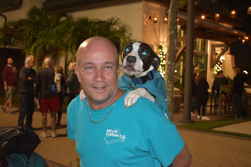 Bobo the dog hitches a ride on the back of her owner, Ken Harpley of Palmetto.
