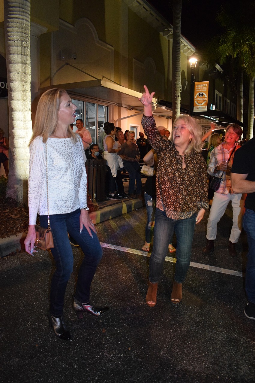 Lakewood Ranch's Violette Kaszubski and Lisa Buck dance together in front of the stag as Derek Lersch performs.