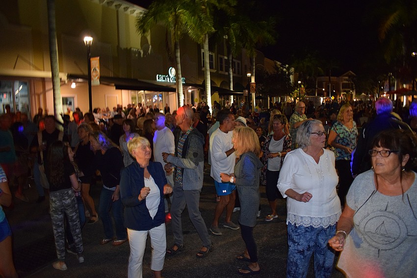 People dance in front of stage.