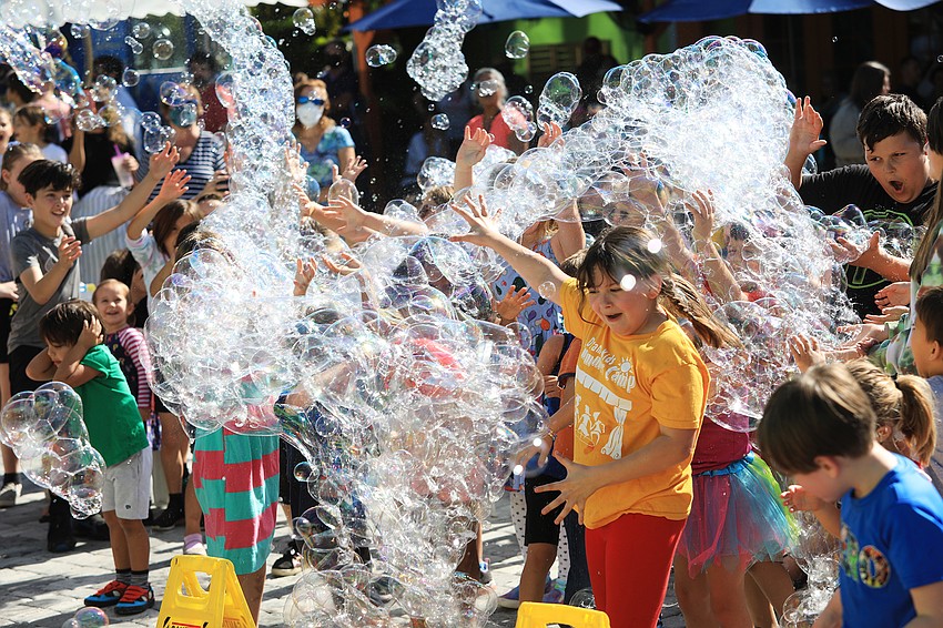 Dozens of children chased after the bubbles floating through the bazaar.