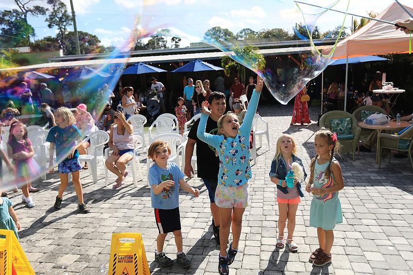 Dozens of children chased after the bubbles floating through the bazaar.