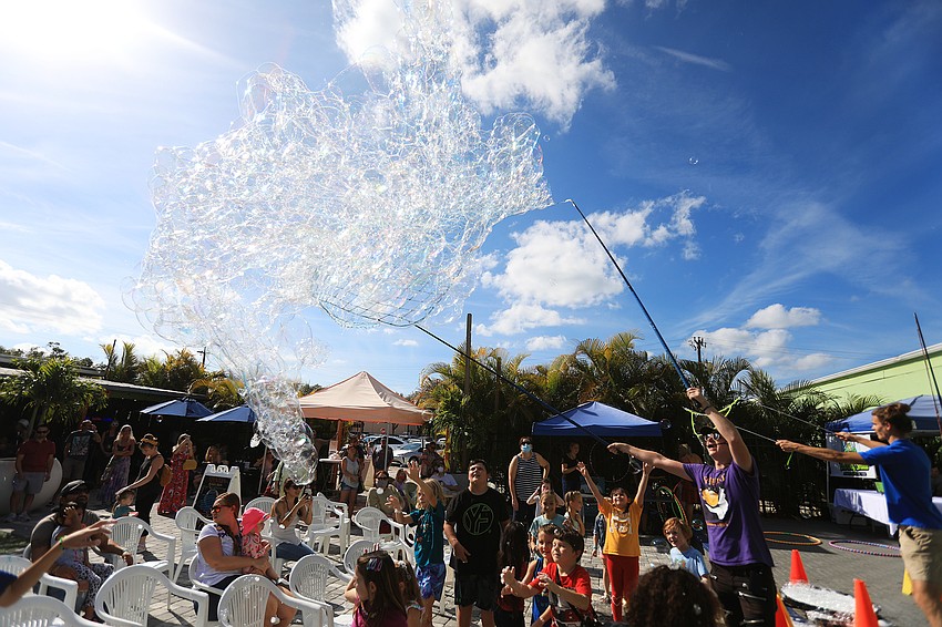 Dozens of children chased after the bubbles floating through the bazaar.