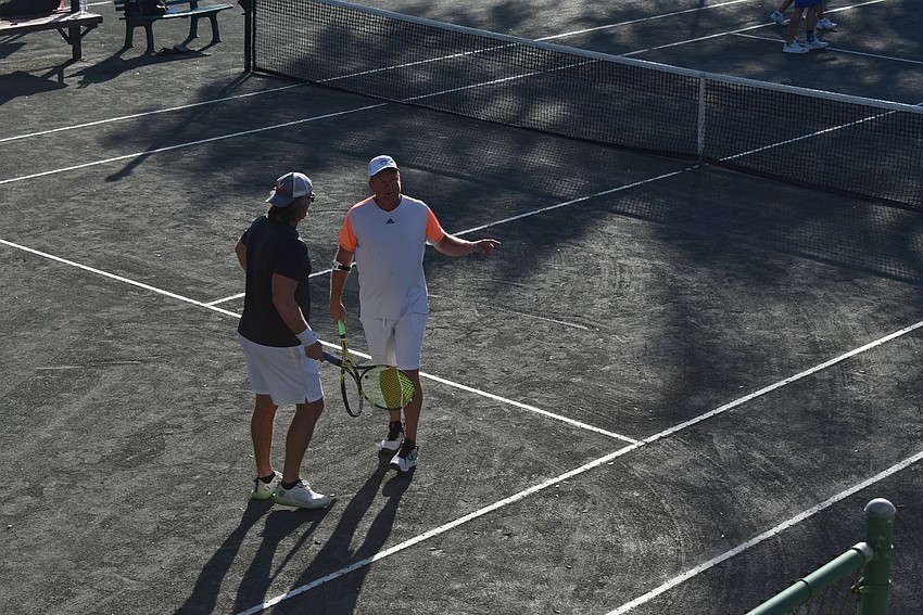 Dustin Keith and Dave Barcomb discuss before a point in the Division 1 consolation round.