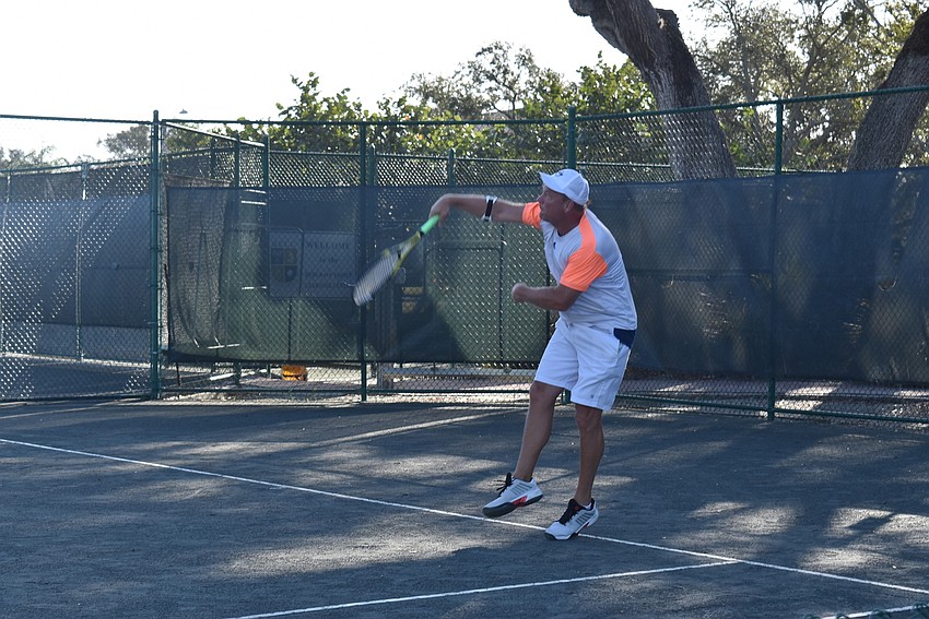 Dave Barcomb smashes a ball on a return.