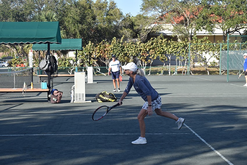 Peggy Lavallee swings low for a point.