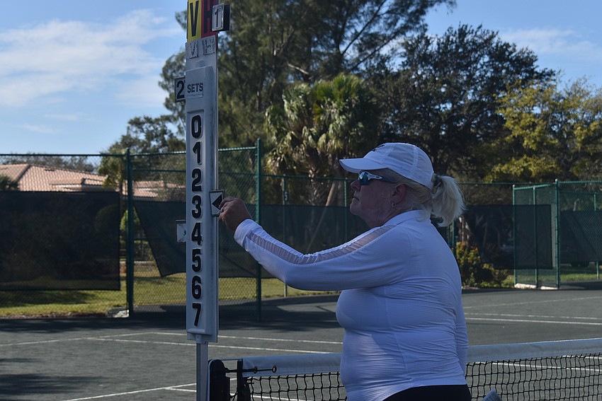 Stacey Allerton adjusts the scoreboard during the Division 1 final.