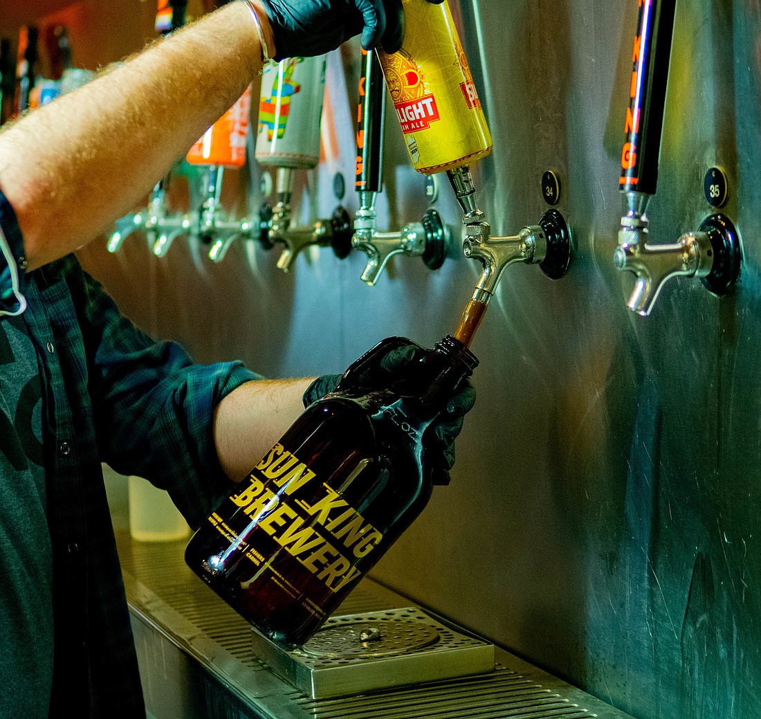 A Sun King employee pouring beer into a growler. Sun King&#39;s new Sarasota location will open this summer. Courtesy photo