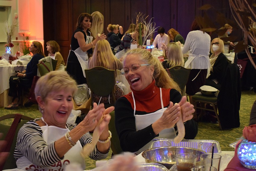 Bradenton's Mira Johns and Pam Wiersma roll out their dough so they can braid it.
