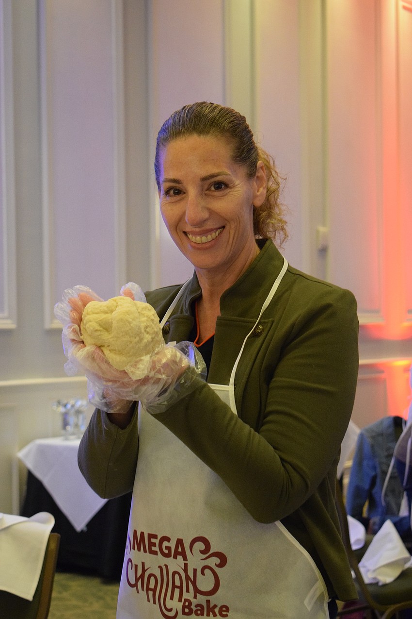 Sarasota's Ilanit Klang-Geffre shows off her challah dough.