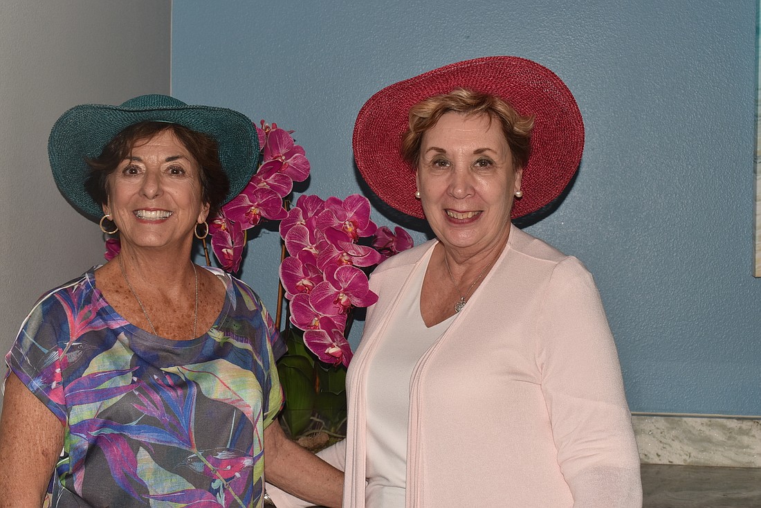 Lesley Rife and Karen Pashkow in hats similar to what they&#39;ll wear for the fashion show.
