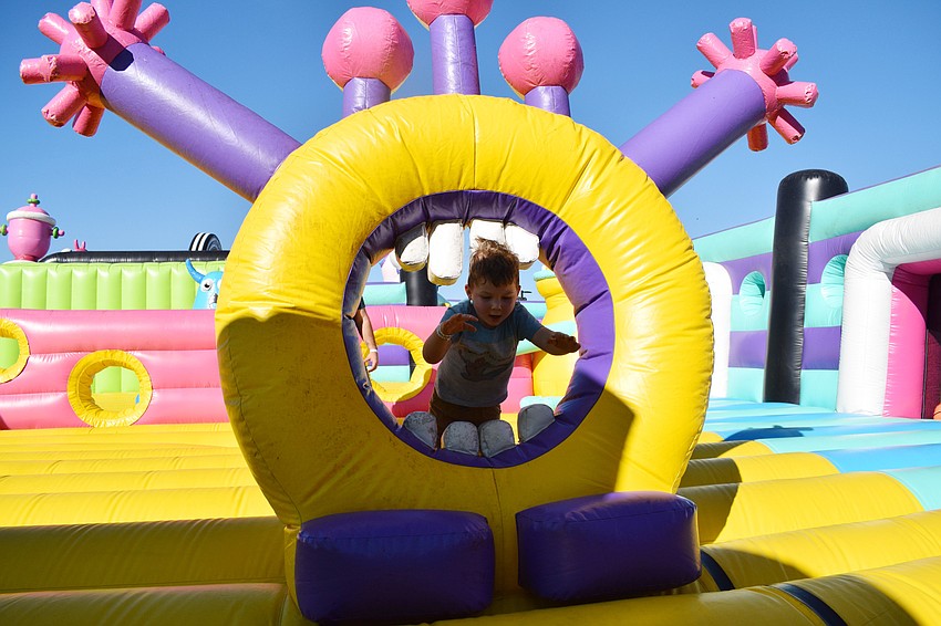 Tampa's Noah Burdette, who is 3 years old, launches himself through an inflatable creature.