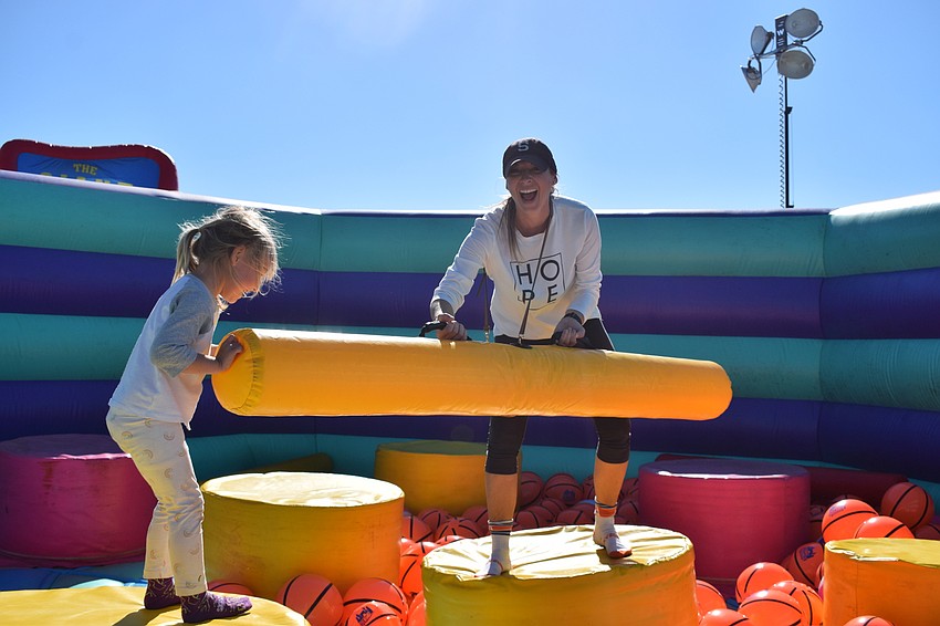 East County's Olivia Swift, who is 3 years old, gets a tap from her mother, Sarah Swift.