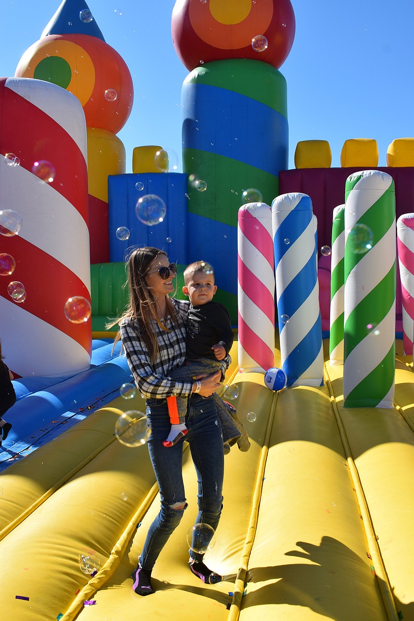 Lakewood Ranch's Joanna McGrady and her 22-month-old son Alec McGrady bounce while surrounded by bubbles.