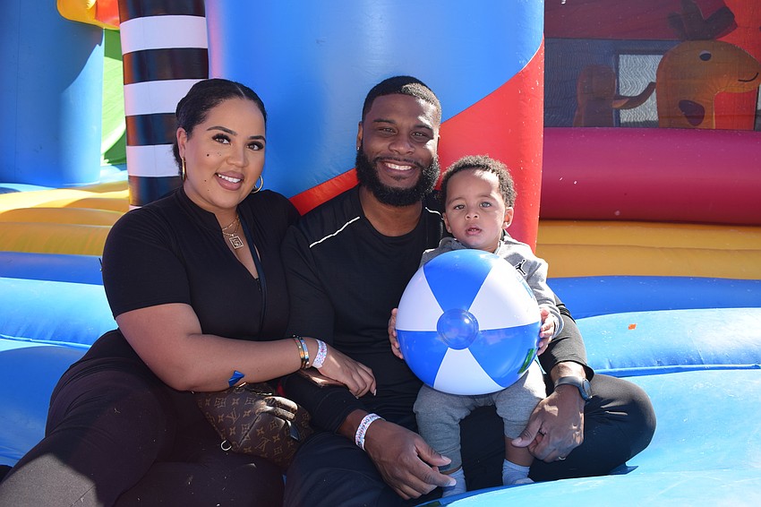 Tampa's Adrianna King and her husband, Harold King, and 1-year-old son Elijah King have fun listening to music and playing with bubbles in the bounce house.