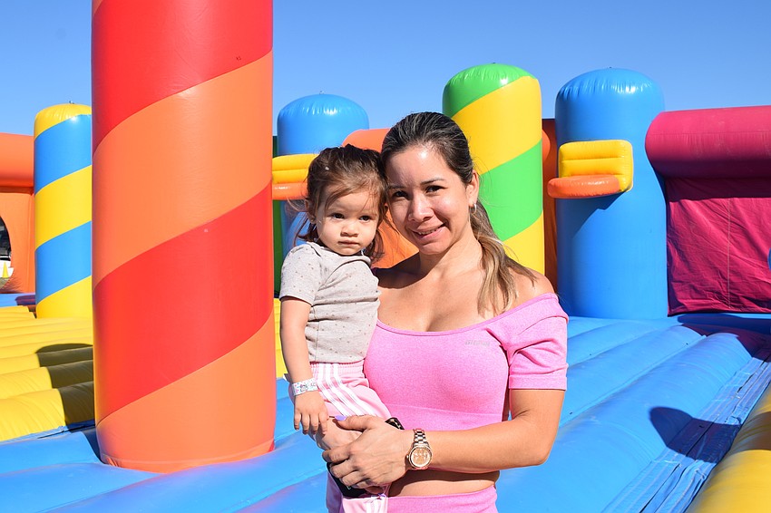 Tampa's Emma Perez, who is 2 years old, has fun with her mother, Yaquelin Perez. Yaquelin Perez said the giant bounce castle is the best of all the attractions.