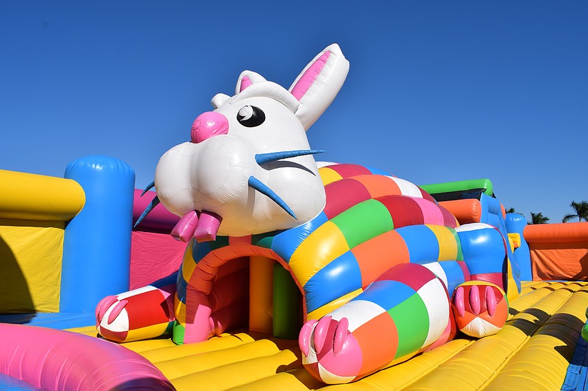 A giant inflatable rabbit hides a small obstacle course that leads to a slide.
