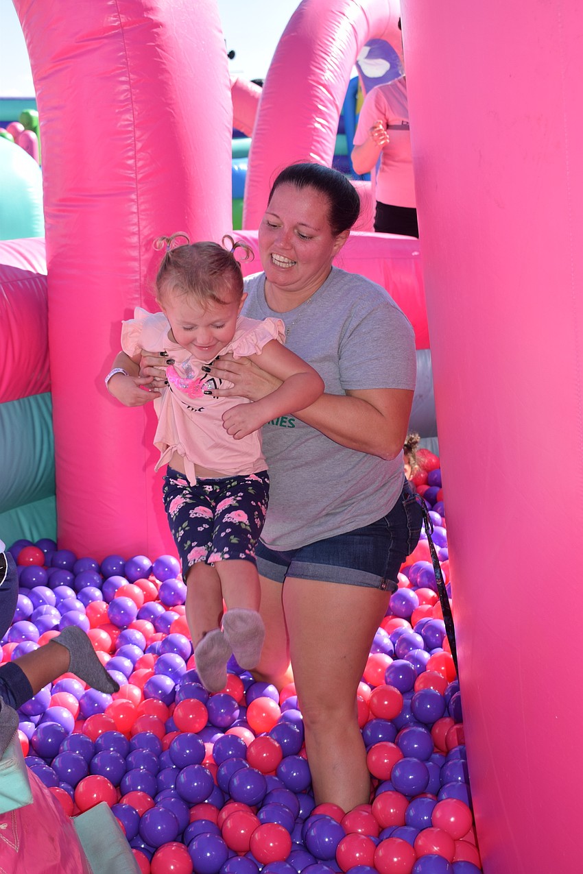 Cape Coral's Ana Andrea prepares to toss her 3-year-old daughter Nacialei Andrea in a ball pit.