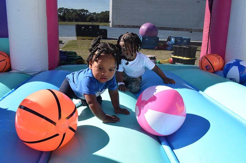 Port Charlotte's Loyal Turner, who is 1, has fun playing in a bounce house with his 3-year-old brother Carmellion Turner.
