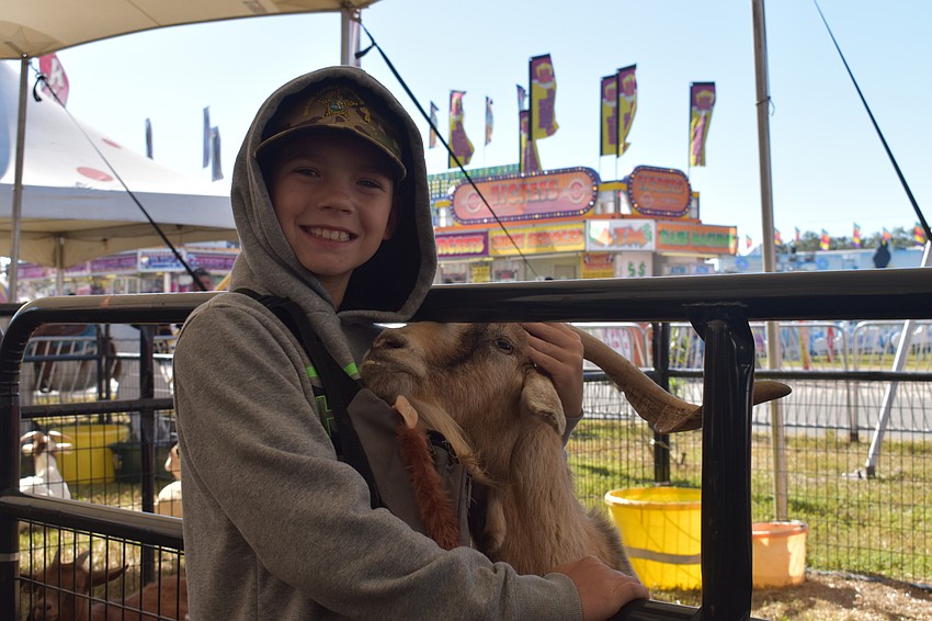 Austin Gardieff of Ruskin gets close to a goat in the petting zoo.