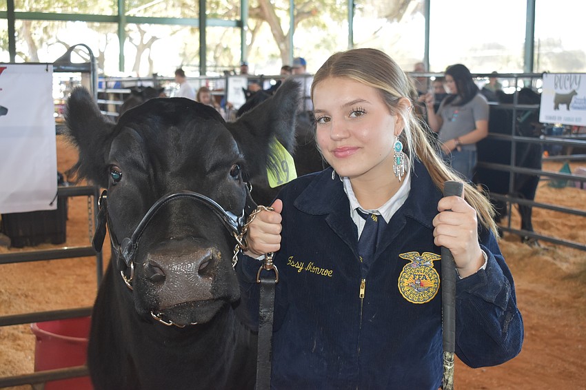 Isabelle Monroe of the Lakewood Ranch High FFA poses with her cow Hemi.