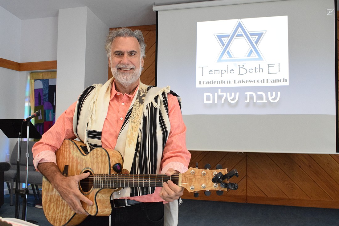Rabbi Tuviah Schreiber, a self-taught guitar players, will play guitar during services. Photo by Liz Ramos.