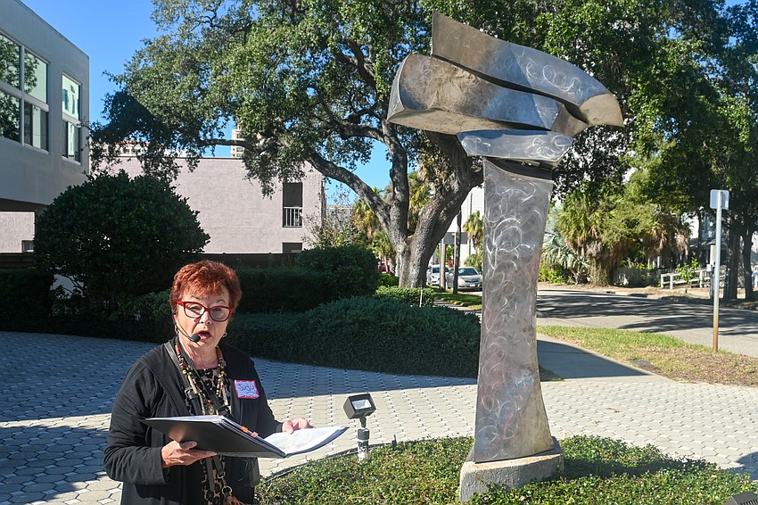 Arts Advocate docent Judy Levine speaking in front of the Clockwork of Convergence sculpture by Vicky Randall. (Photo: Spencer Fordin)