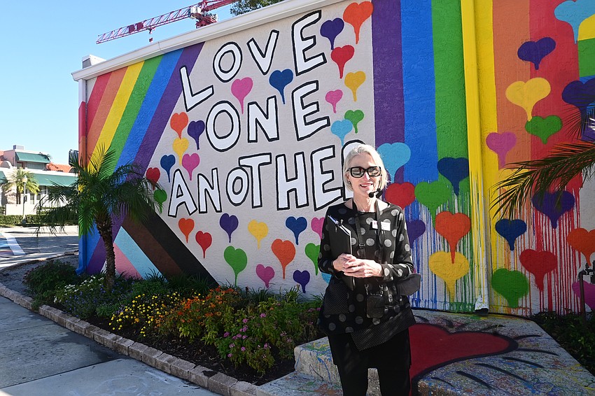Arts Advocate docent Stephenie Frasher stands in front of Brandon Thrift's 
