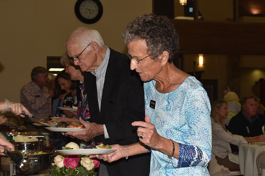 Sue Wertman gets dinner from the buffet line