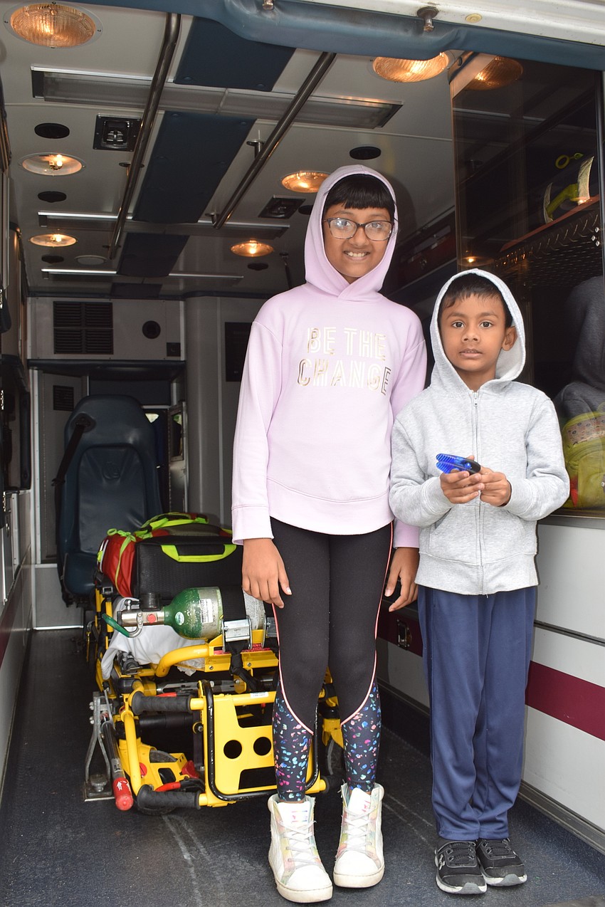 Lakewood Ranch 9-year-old Yashaswi Gupta and 4-year-old Yatharth Gupta visit the back of the Search Rescue Manatee County vehicle.
