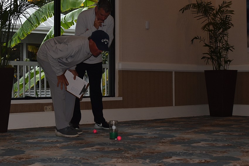Terry O'Hara checks the distance of a putt.