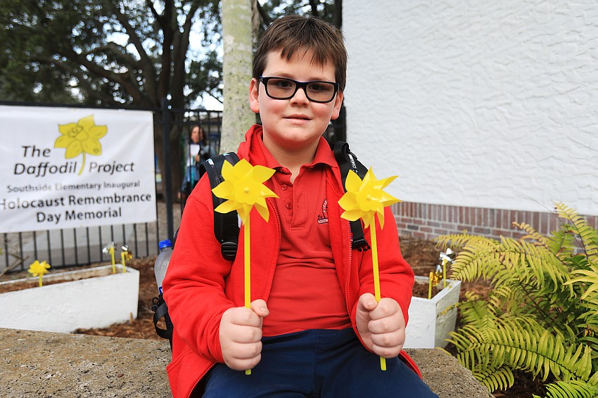 Royal Devlin holds two pinwheels.