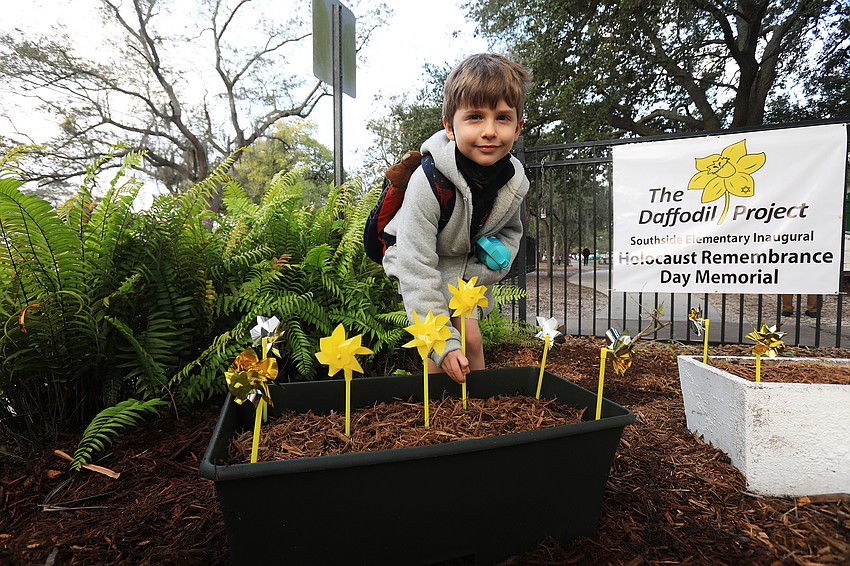 Teddy Leary plants a pinwheel