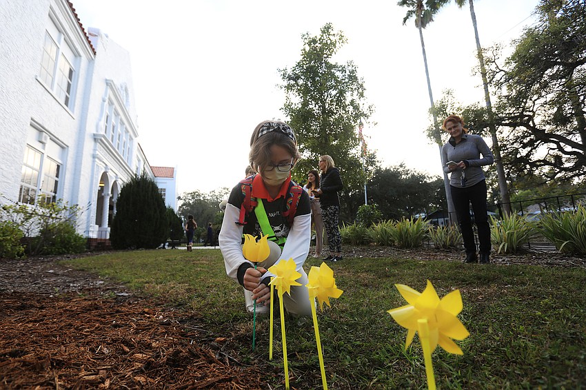 Tegan Conner plants her pinwheel.