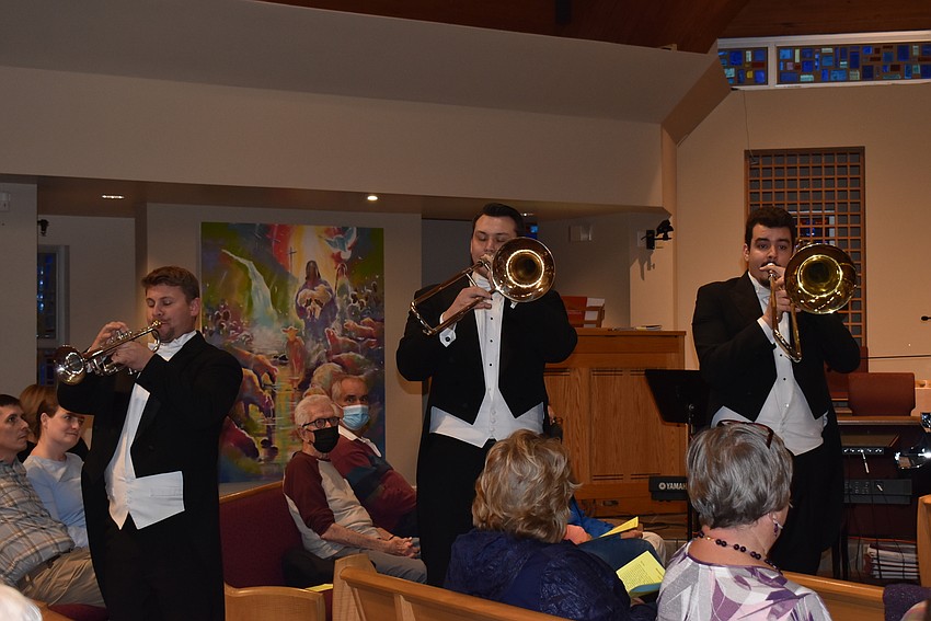 Three trombonists started the concert in the audience.