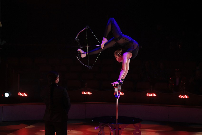 Elayne Kramer shoots an arrow with her hand balancing act.